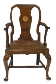 A George II mahogany armchair, circa 1740, the cartouche shaped back and vase shaped splat, flanked