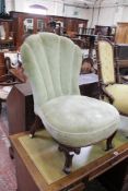 A Victorian mahogany nursing chair with shaped back