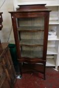 An Edwardian mahogany and inlaid serpentine front display cabinet