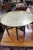 A Middle Eastern brass tray top table