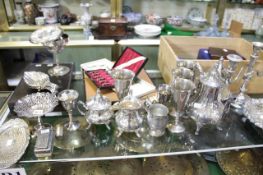 A collection of silver, silver coloured and plated wares, including a silver twin handled trophy