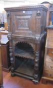 A carved oak cupboard, in 16th century style 149cm high, 70cm wide