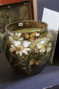 A late 19th century Continental pottery jardiniere on stand, circa 1900, hand painted in coloured