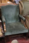 A Gainsborough style armchair in green upholstery.
