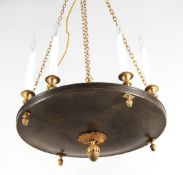 A patinated and gilt metal eight light electrolier in Empire taste, 20th century, the electrical