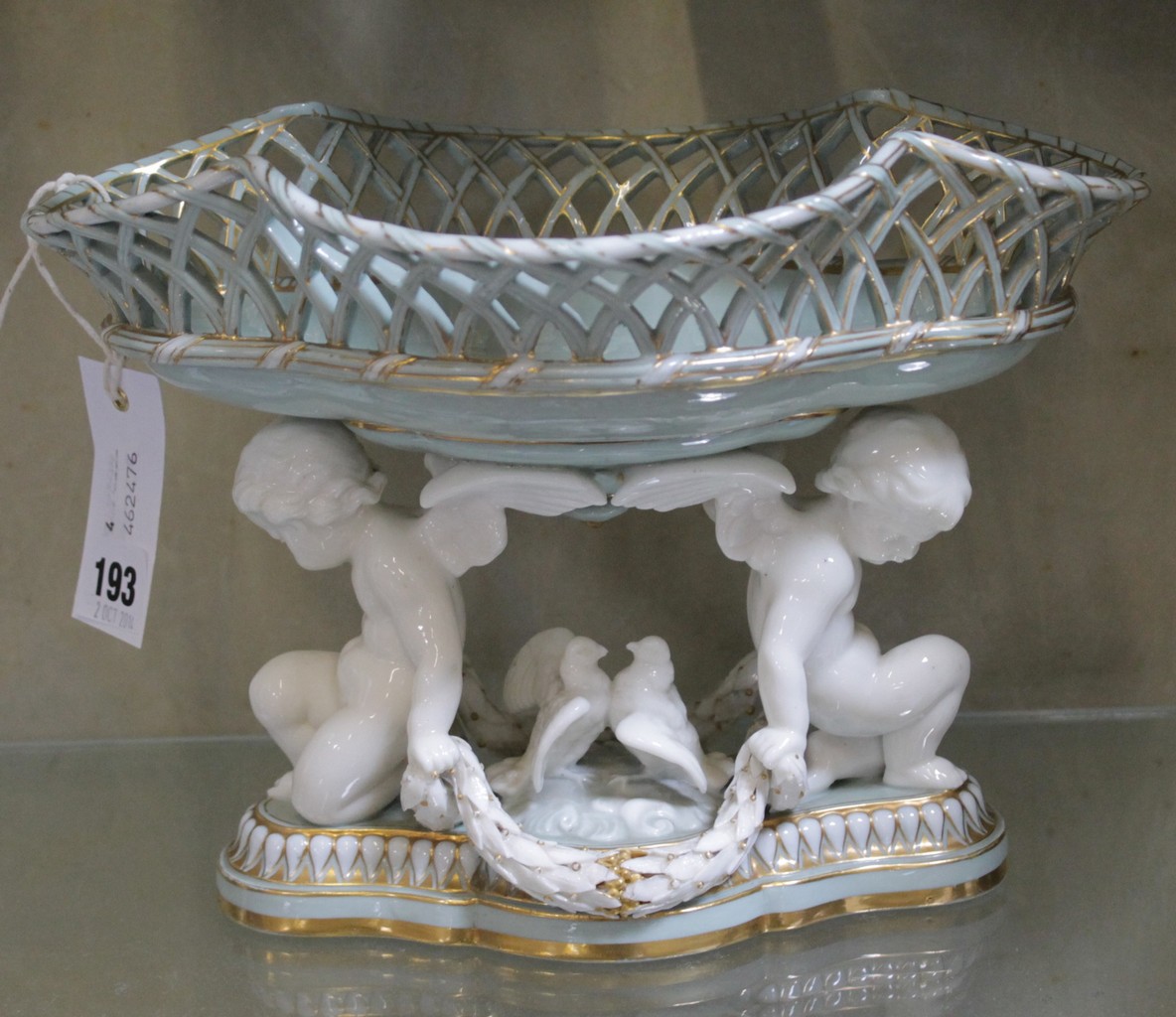 A Minton celadon ground figural centrepiece, impressed mark to base; 20cm high