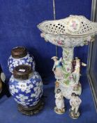 A German porcelain figural centrepiece, a pair of blue and white Chinese ginger jars, woodcovers
