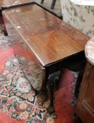 A Georgian mahogany drop leaf table with oval top and cabriole legs and ball and claw feet