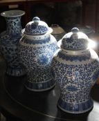 A pair of 20th Century blue and white Chinese vases and covers; 44cm high each, together with one