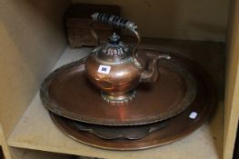 An Arts & Crafts hammered copper tray, two others, a kettle and a carved treen box Best Bid