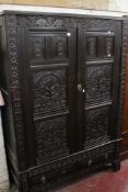 A 19th century Jacobean style oak court cupboard, bearing the date 1690 over a pair of heavily