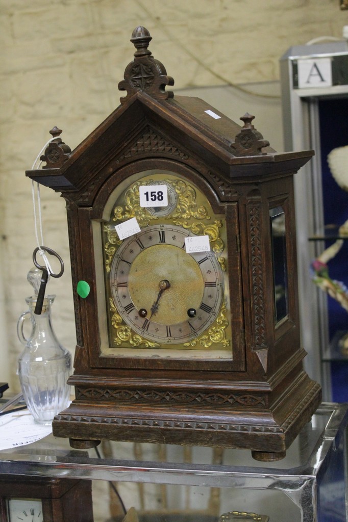 A Victorian carved oak mantel clock, late 19th century, the eight-day gong striking movement by