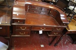 A Carlton House style mahogany desk, with a raised back of drawers over three frieze drawers,