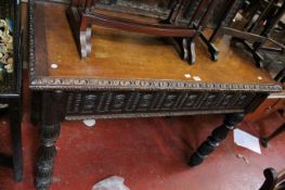 A 19th century Jacobean style side table with a heavily carved panelled raised back. 1.25 cm wide