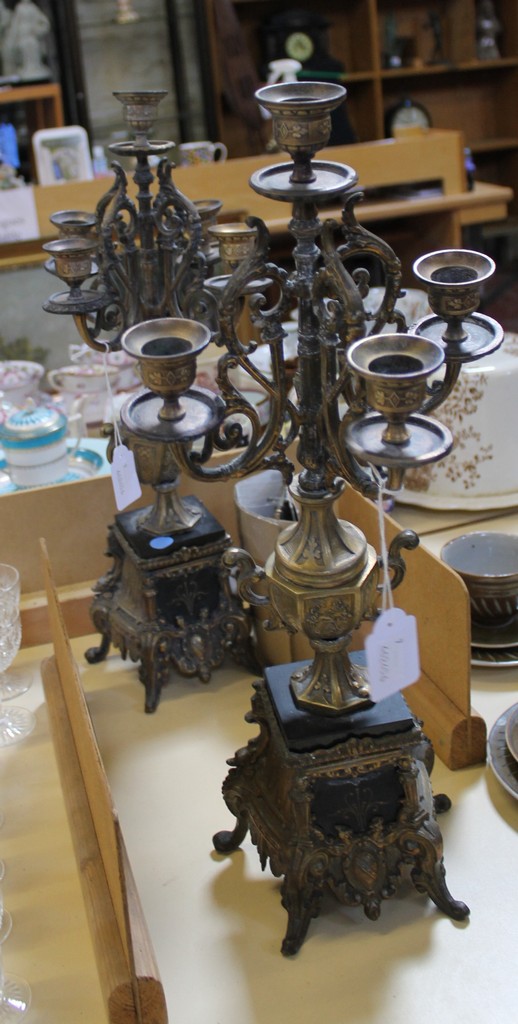 A pair of brass mounted five sconce candlestick holders