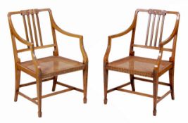 A pair of painted beech and caned armchairs in George III Sheraton style, 20th century, painted