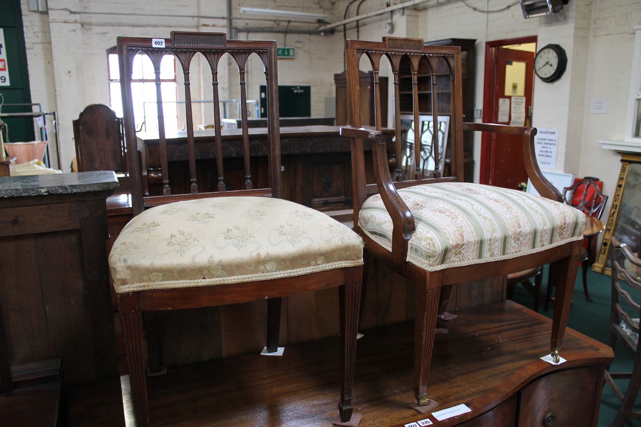 An early 20th century elbow chair and side chair in the Georgian style.