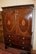 A George III mahogany linen press with oval inlaid doors over two short and two long drawers 197cm