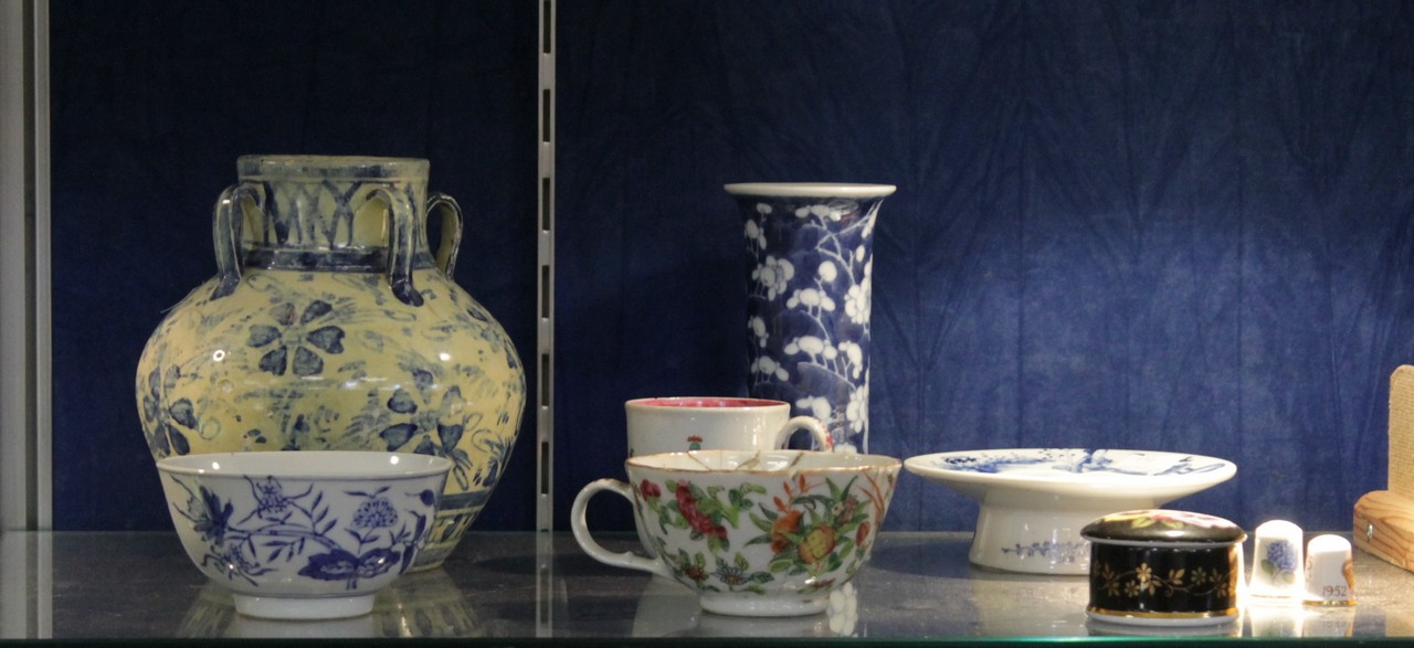 A Chinese blue and white prunus blossom decorated spill vase; 15cm high, together with a small