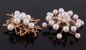 Two cultured pearl brooches, the first in the form of a radiating star  Two cultured pearl brooches,