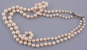 A double stranded graduated cultured pearl necklace  A double stranded graduated cultured pearl