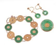 An Oriental jadeite panel bracelet, composed of circular discs of jadeite...  An Oriental jadeite