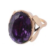 An amethyst ring, the oval shaped amethyst in a closed back setting  An amethyst ring,   the oval