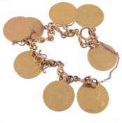 A gold fancy link bracelet suspending various guinea coins  A gold fancy link bracelet suspending