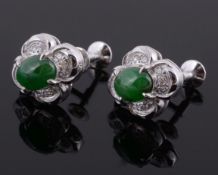 A pair of jadeite and diamond earrings, the quatrefoil earrings with a...  A pair of jadeite and