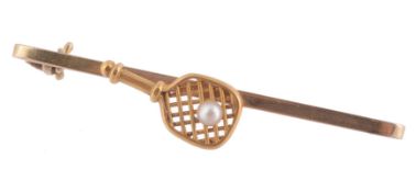 A tennis racquet bar brooch , the tennis racquet with a seed pearl accent  A tennis racquet bar