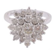 A diamond cluster ring, the graduated brilliant cut diamonds in a undulating...  A diamond cluster