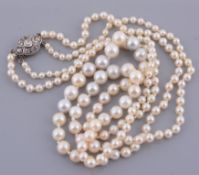 A graduated two strand cultured pearl necklace  A graduated two strand cultured pearl necklace,