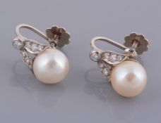 A pair of pearl and diamond earrings, the 9  A pair of pearl and diamond earrings,   the 9.4mm