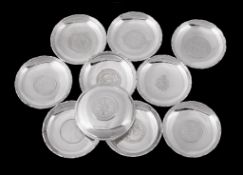 Ten similar Chinese export silver coloured circular small trays, stamped marks  Ten similar