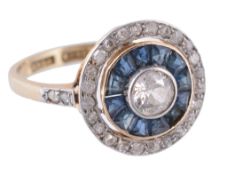 A sapphire and diamond ring, the central old brilliant cut diamond in a...  A sapphire and diamond