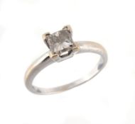 A diamond single stone ring, the princess cut diamond in a four claw setting  A diamond single stone