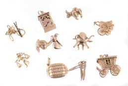 A collection of charms, to include a 9 carat gold elephant charm; a 9 carat...  A collection of