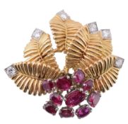 A ruby and diamond brooch, the textured leaves set with brilliant cut...  A ruby and diamond brooch,