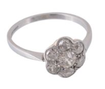 A diamond cluster ring, the central old brilliant cut diamond  A diamond cluster ring,   the central