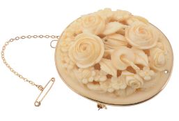 A carved ivory brooch, the oval shaped brooch carved with a foliate scene, 4  A carved ivory brooch,