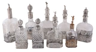 A group of nine Continental silver coloured mounted glass decanters  A group of nine Continental