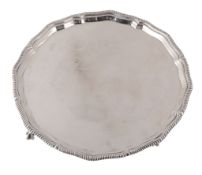 A silver shaped circular salver by The Goldsmiths & Silversmiths Co  A silver shaped circular salver