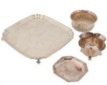 Four silver items, comprising: a square small salver by Reid & Sons of...  Four silver items,