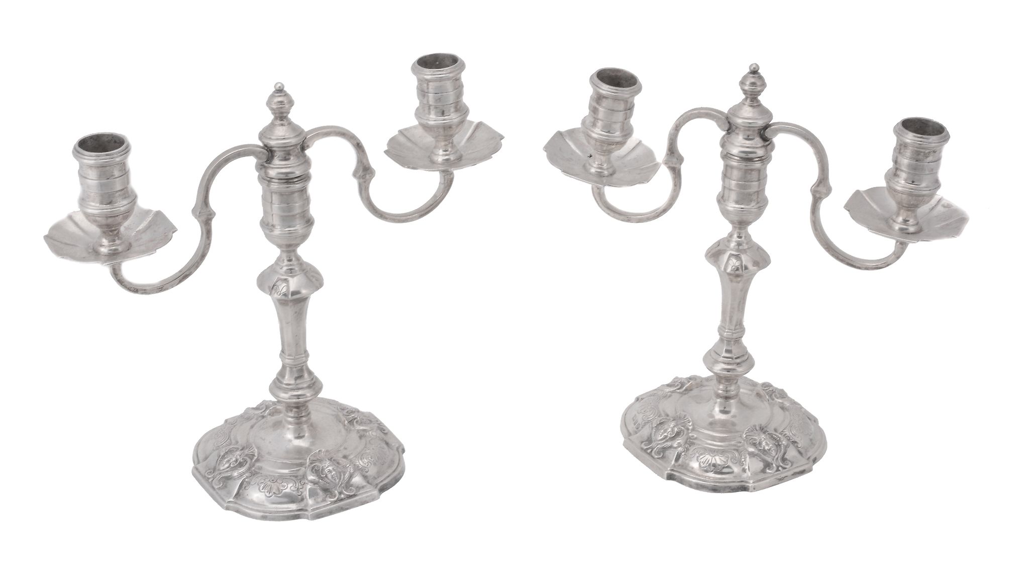 A pair of cast silver twin light candelabra by Nayler Brothers, London 1962  A pair of cast silver