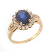 A sapphire and diamond cluster ring, the oval shaped sapphire in a four claw...  A sapphire and