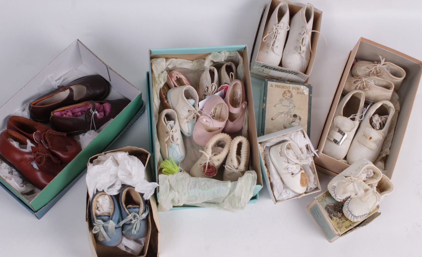 A collection of children`s shoes, comprising: a pair of cream satin Edwardian pageboy shoes, a