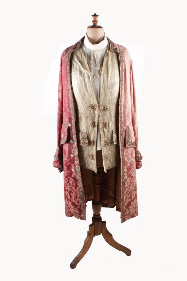 A pink brocade gentleman`s coat trimmed with metallic lace, with a gold metallic woven waistcoat