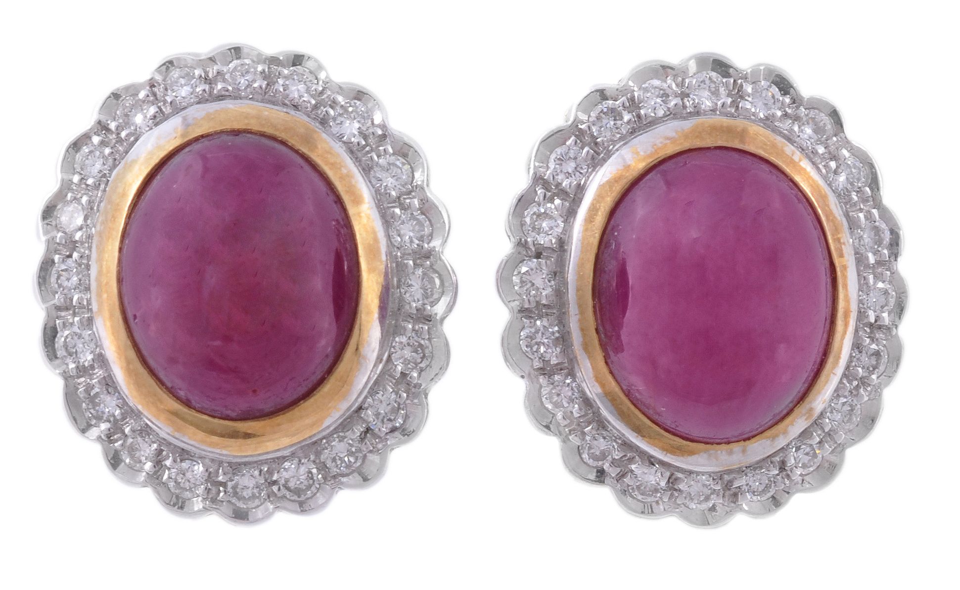 A pair of ruby and diamond ear clips, the central oval cabochon ruby in a...  A pair of ruby and