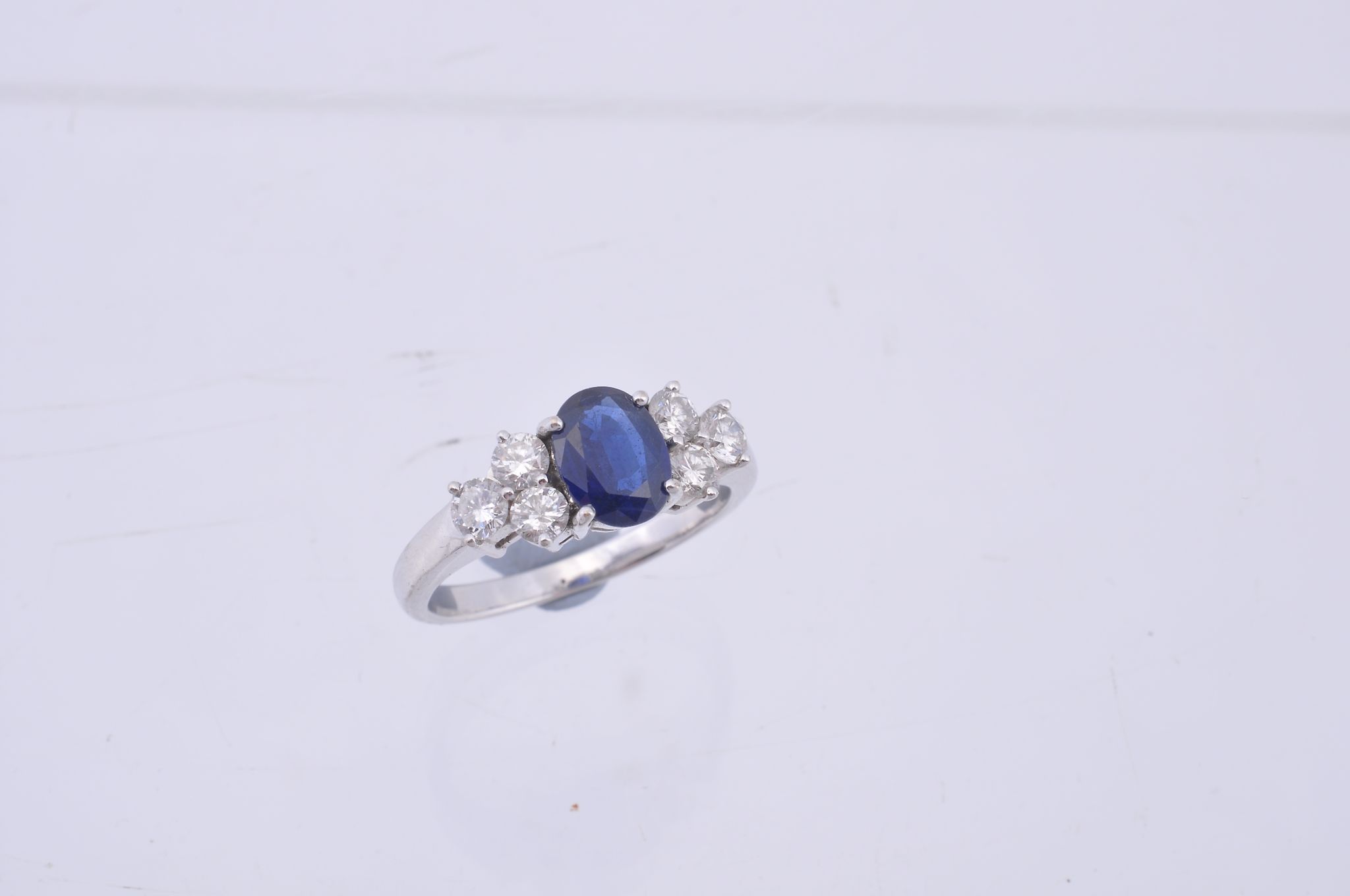 A sapphire and diamond seven stone ring, the central oval cut sapphire...  A sapphire and diamond