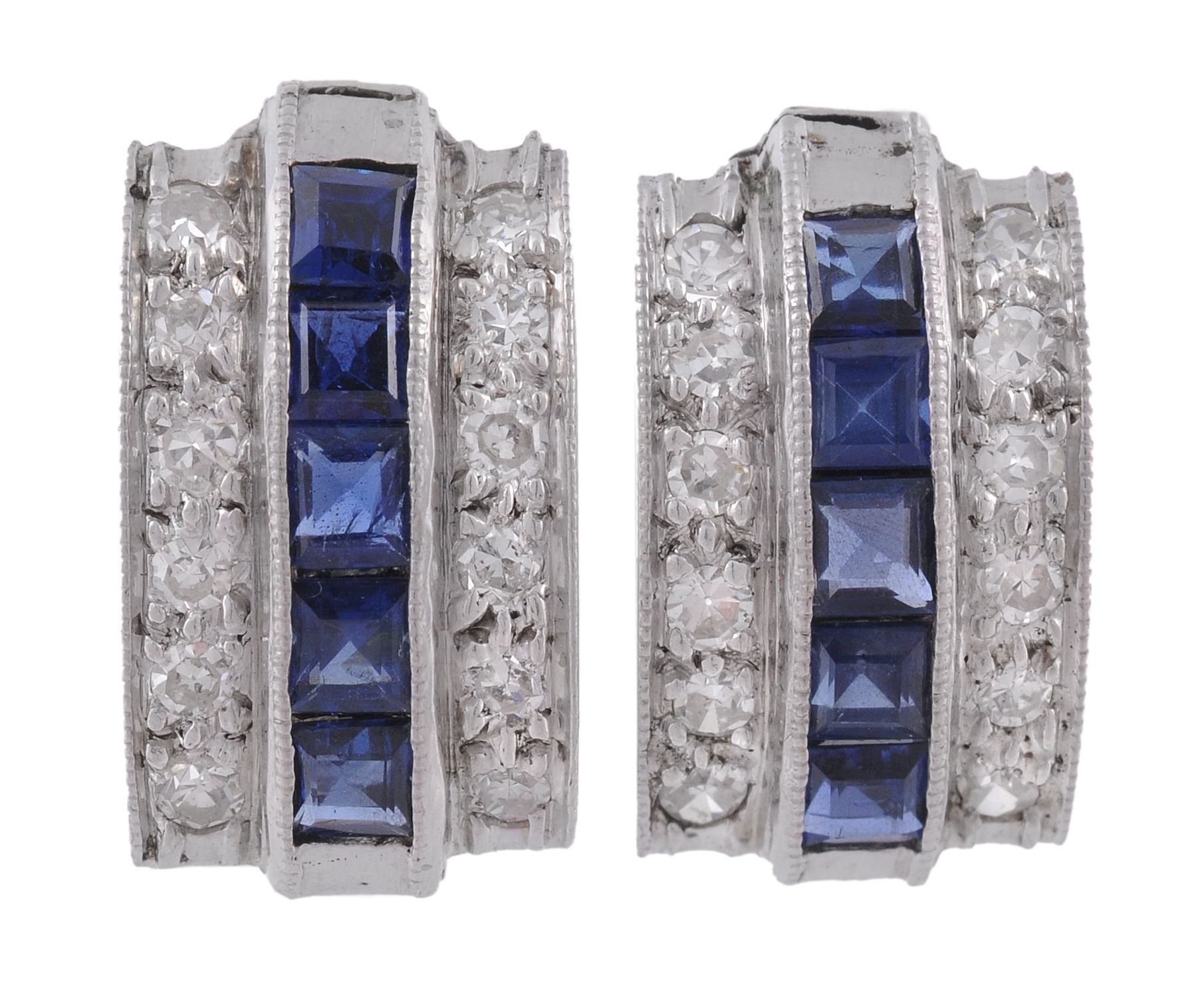 A pair of diamond and sapphire ear clips, the panels set with a central row...  A pair of diamond